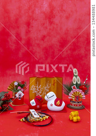 A gorgeous New Year's image featuring a red and white horse figurine, kadomatsu (New Year's pine decorations), and a gold folding screen against a vibrant red background. A gorgeous New Year's image featuring a red and white horse figurine, kadomatsu (New Year's pine decorations), and a gold folding screen against a vibrant red background. 134488981