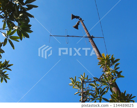 Disaster prevention speakers and trees stretching into the blue sky 134489025
