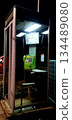 A public telephone looming in the darkness of the night 134489080