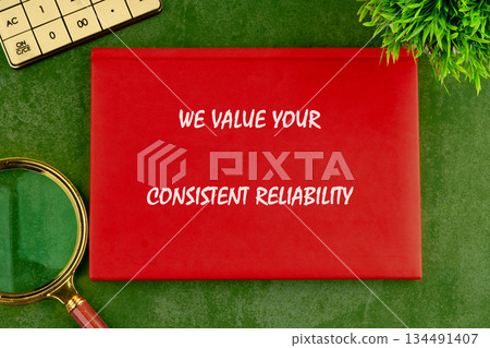 A crimson placard stating We Value Your Consistent Reliability rests on a vibrant green surface beside a magnifying glass, calculator, and a plant, suggesting business acumen and growth A crimson placard stating We Value Your Consistent Reliability rests on a vibrant green surface beside a magnifying glass, calculator, and a plant, suggesting business acumen and growth 134491407