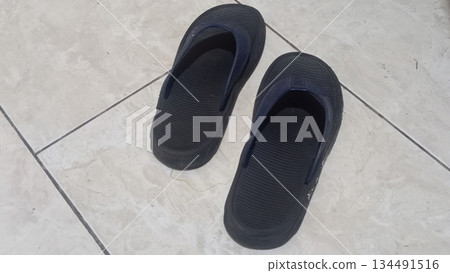 4k detailed black sandals on ceramic floor 4k detailed black sandals on ceramic floor 134491516
