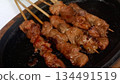 4k detailed chicken satay grilling on hot plate 134491519