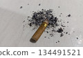 4k closeup cigarette butt with scattered ashes 134491521