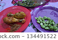 Fried chicken and fresh vegetable side dishes on colorful plates captured in 4k 134491522
