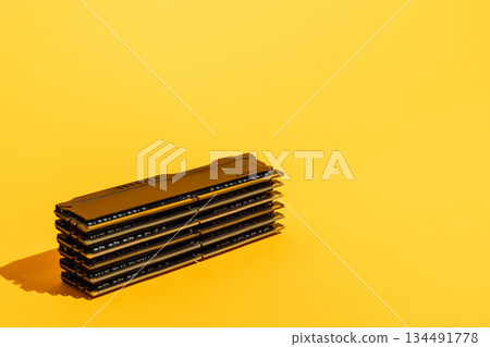 Stack of RAM memory modules on bright yellow background Stack of RAM memory modules on bright yellow background 134491778