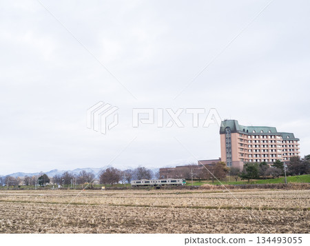 [Yamagata Line] A local train running through the winter countryside 134493055