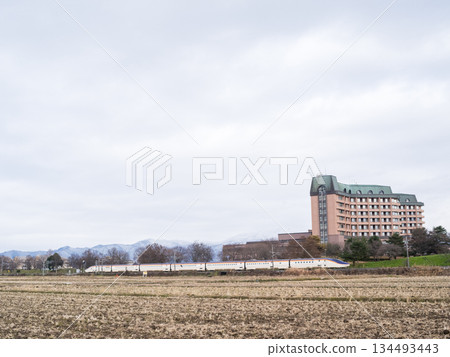 [Yamagata Line] Limited Express Tsubasa train running through the winter countryside 134493443