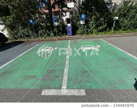 Parking lot with two electric car charging stations Parking lot with two electric car charging stations 134493970