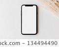 Smartphone mockup with blank screen on white surface 134494490