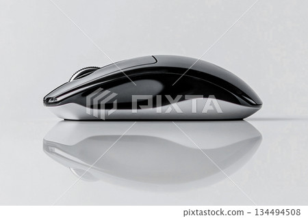 Wireless computer mouse on reflective desk surface 134494508