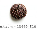 Chocolate glazed pastry with decorative stripes on white background 134494510