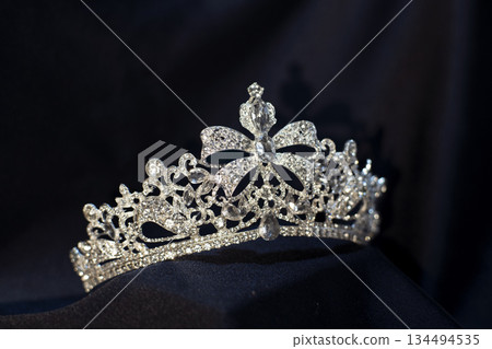 Luxury golden royal crown, diadem with bow detail. 134494535