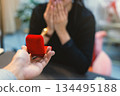 First person view of man proposing with red ring box 134495188