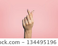 Korean finger heart hand gesture isolated on pink background 134495196