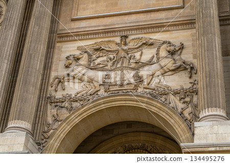 Horses on old wall facade house building in Paris Louvre museum Colonnade gate detail Napoleon I relief sculpture in architecture. Arch columns. France street Horses on old wall facade house building in Paris Louvre museum Colonnade gate detail Napoleon I relief sculpture in architecture. Arch columns. France street 134495276