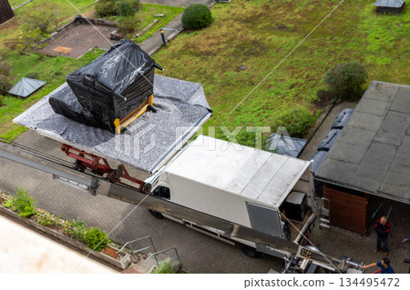 House terrace mover service lift ladder cargo crane platform wrapped armchair film city street. Retractable furniture elevator machine car pickup truck rental company relocation house move delivery House terrace mover service lift ladder cargo crane platform wrapped armchair film city street. Retractable furniture elevator machine car pickup truck rental company relocation house move delivery 134495472