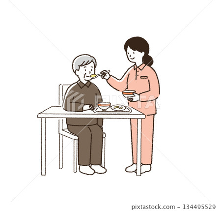 Caregiver assisting with meals 134495529