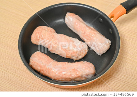Grilling rice paper sausages 134495569