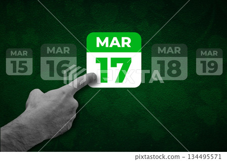 St. Patrick Day calendar, March 17. Halftone collage: a hand pointing to a calendar with the date March 17. 134495571