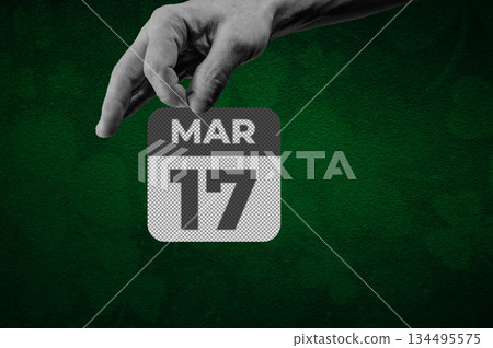 St Patrick day March 17th Calendar Page. Halftone collage of a hand holding a calendar page with the words March 17 134495575
