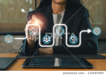 Businesswoman using digital interface for strategic planning, highlighting growth and development concepts. Businesswoman using digital interface for strategic planning, highlighting growth and development concepts. 134495909