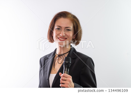 A portrait of the speaker in a black jacket, with a confident gaze and calm delivery. 134496109