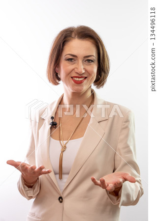 A woman on a white background gestures with her hands, explaining information to the viewer. A woman on a white background gestures with her hands, explaining information to the viewer. 134496118