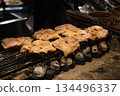 Grilled pork skewers on a charcoal grill 134496337