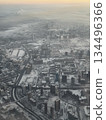 Panoramic aerial view of winter city with snowy rooftops and roads at sunrise. 134496366
