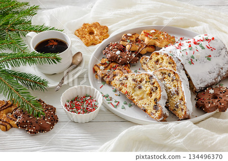 Traditional German Christmas Stollen with marzipan and cookies on white wooden table Traditional German Christmas Stollen with marzipan and cookies on white wooden table 134496370
