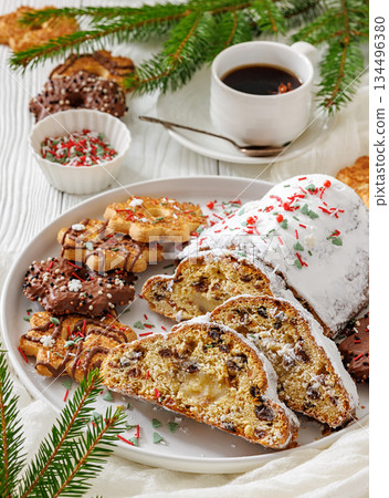Traditional German Christmas Stollen with marzipan and cookies on white wooden table 134496380