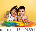 Happy diverse children playing with colorful paint 134496394