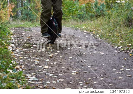 man rides down the trail on a monocycle. close up unicycle. man rides down the trail on a monocycle. close up unicycle. 134497233