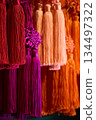 Decorative tassels with vibrant red and purple tassels and decorative knots 134497322