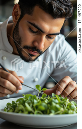 Young Hispanic Male Chef Adding Microgreens Final Garnish Art 20s man, chef whites tweezers, delicately adding microgreens final artistic garnish 134497990