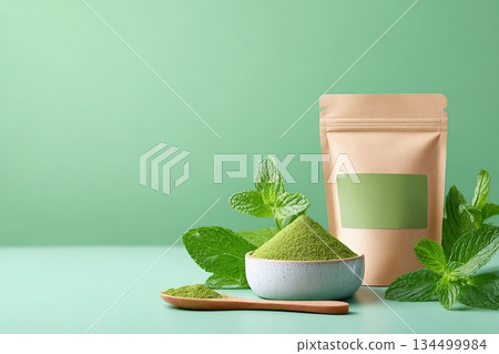 Healthy algae snack packaging showcased on a mint-green backdrop with fresh mint leaves 134499984