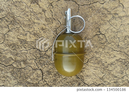 Combat hand grenade on dry cracked earth Combat hand grenade on dry cracked earth 134500186
