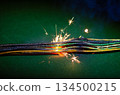 Short-circuit sparks on colored electrical wires. 134500215