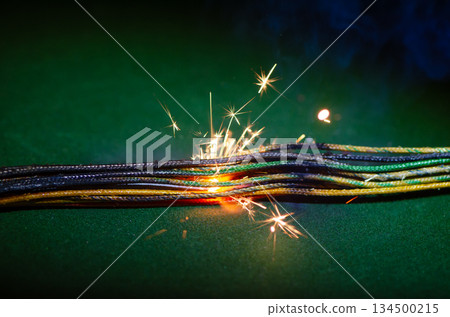 Short-circuit sparks on colored electrical wires. 134500215