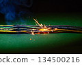 Smoldering electrical wires emit smoke and sparks when the system is dangerously overloaded. 134500216
