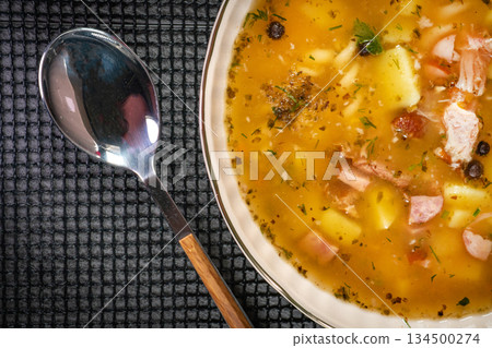 Pea soup with pieces of white sausage, potatoes and small dumplings. 134500274