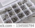 Set of assorted screws organized in plastic storage box on gray background. Hardware tools concept. 134500794