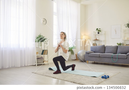 Yogi old sporty senior, fit woman knee practicing, stretching, yoga at home, exercise, relax pose 134500832