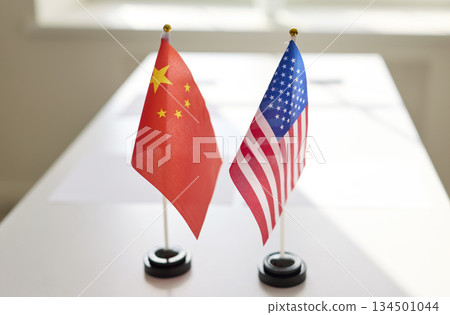 United States and China desk flags signal diplomatic meeting at table today 134501044