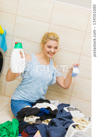 Girl doing laundry choose best detergent. Girl doing laundry choose best detergent. 134501080
