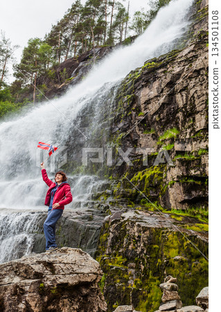 Tourist woman at waterfall Svandalsfossen, Norway Tourist woman at waterfall Svandalsfossen, Norway 134501108
