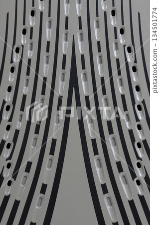 Close-up abstract texture of steam iron soleplate with steam vents Close-up abstract texture of steam iron soleplate with steam vents 134501774