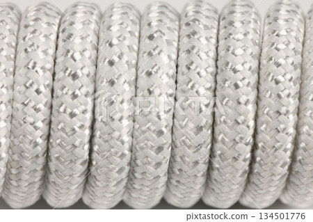 Close-up texture of coiled white braided nylon rope 134501776