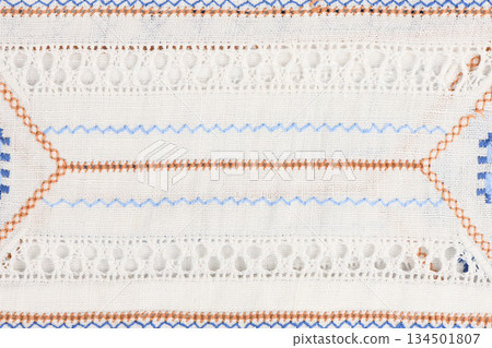 White linen texture with hemstitch and colored embroidery lines White linen texture with hemstitch and colored embroidery lines 134501807
