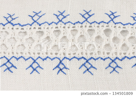 White openwork lace border with blue embroidery on linen White openwork lace border with blue embroidery on linen 134501809